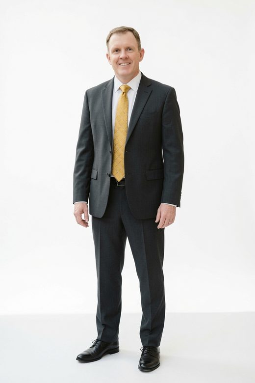Marty Pottinger, full-length portrait in a dark suit